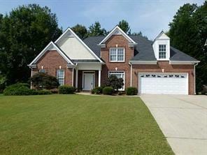 275 Rose Ivy Ct, Lawrenceville, GA 30043 - traditional-style house featuring a front yard, a garage, and driveway