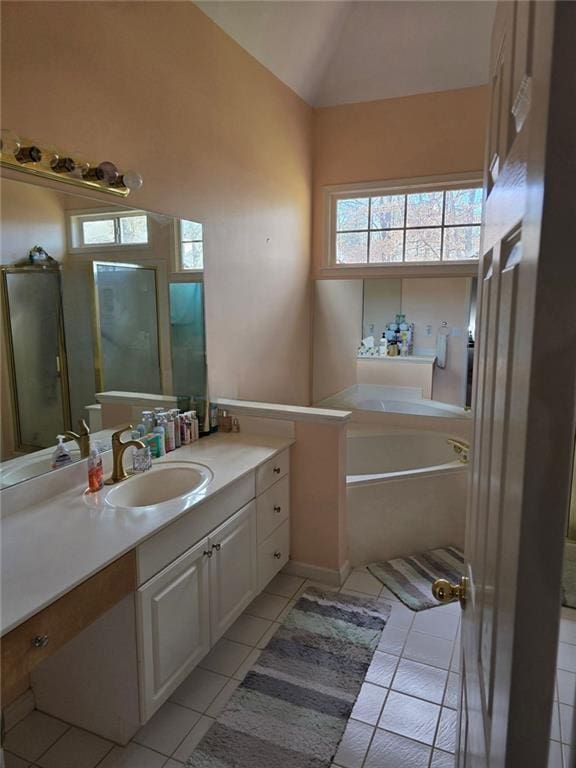 275 Rose Ivy Ct, Lawrenceville, GA 30043 - bathroom with tile patterned flooring, a bath, vanity, and vaulted ceiling