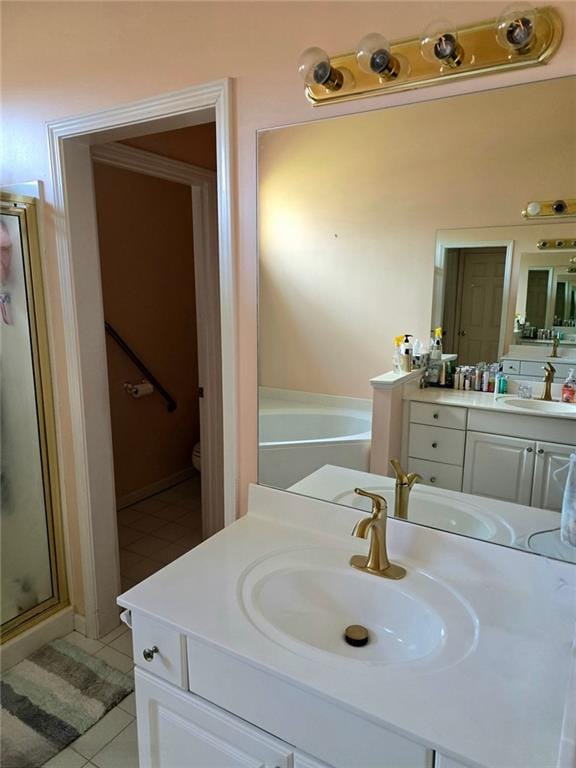 275 Rose Ivy Ct, Lawrenceville, GA 30043 - bathroom with a bath, toilet, vanity, tile patterned flooring, and a stall shower