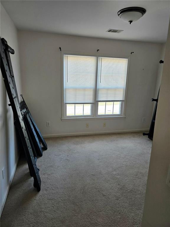 275 Rose Ivy Ct, Lawrenceville, GA 30043 - carpeted empty room with visible vents and baseboards