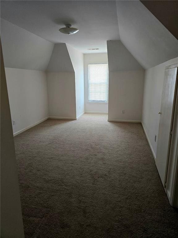 275 Rose Ivy Ct, Lawrenceville, GA 30043 - bonus room with light carpet, baseboards, and vaulted ceiling
