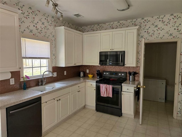 275 Rose Ivy Ct, Lawrenceville, GA 30043 - kitchen with range with electric cooktop, wallpapered walls, stainless steel microwave, and dishwasher