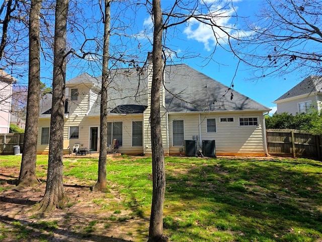 275 Rose Ivy Ct, Lawrenceville, GA 30043 - rear view of property with a yard, central AC unit, and fence