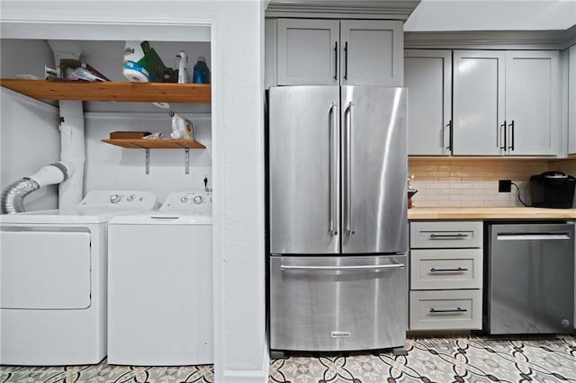 clothes washing area with washer and clothes dryer