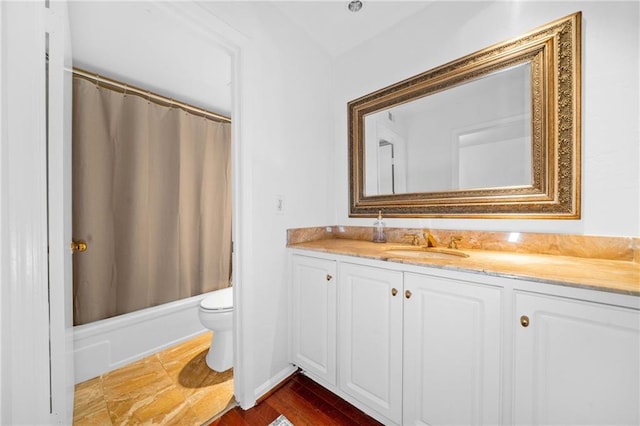 bathroom featuring vanity, toilet, and shower / tub combo with curtain