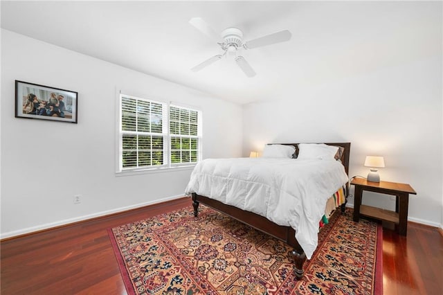 bedroom featuring wood finished floors, baseboards, and a ceiling fan