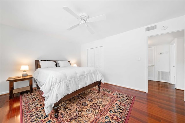 bedroom featuring wood finished floors, baseboards, a closet, and ceiling fan