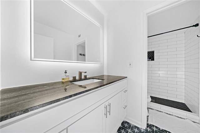 full bathroom featuring a stall shower, toilet, and vanity