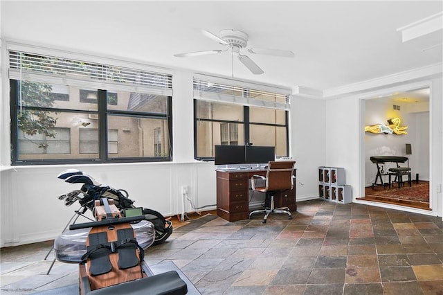 office space with stone tile floors and ceiling fan