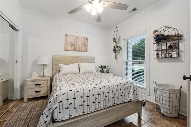 bedroom with ceiling fan, a closet, and ornamental molding