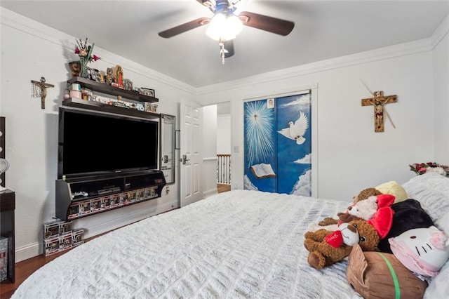 bedroom with hardwood / wood-style floors, ceiling fan, and ornamental molding