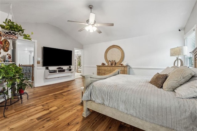 bedroom featuring ensuite bath, ceiling fan, lofted ceiling, and hardwood / wood-style flooring