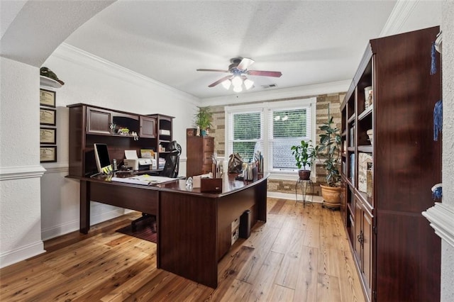 office area with a textured ceiling, ceiling fan, wood-type flooring, and crown molding