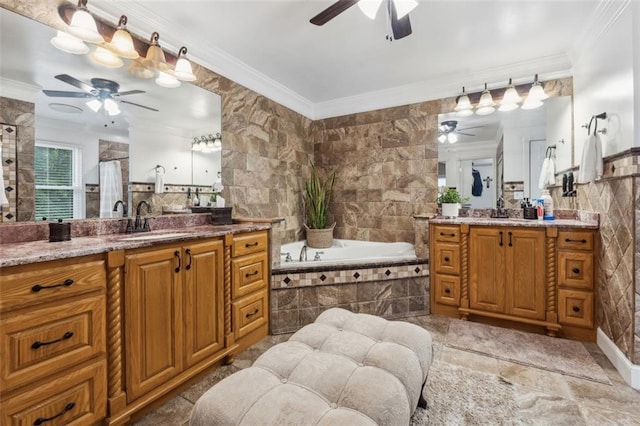 bathroom with vanity, crown molding, and tiled tub