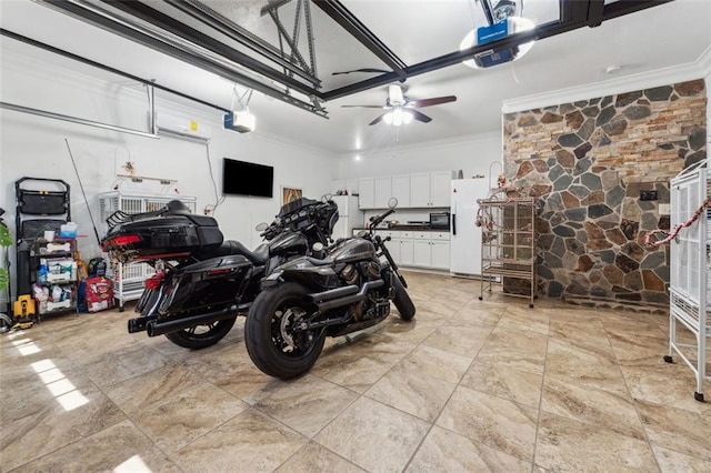 garage featuring ceiling fan, white fridge, and a garage door opener