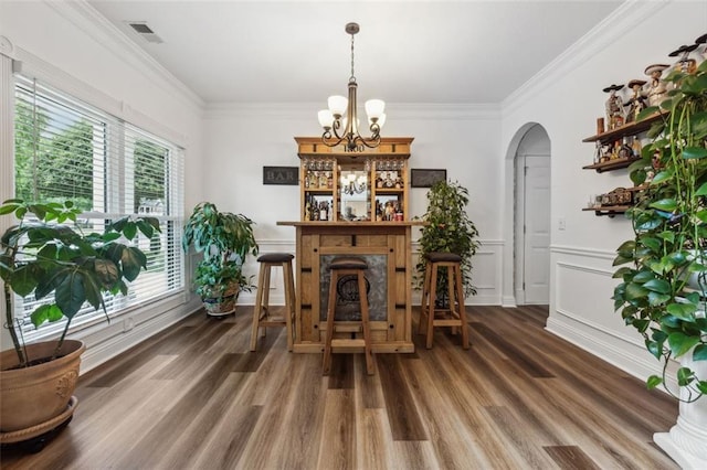 dining area with plenty of natural light, dark hardwood / wood-style floors, and ornamental molding