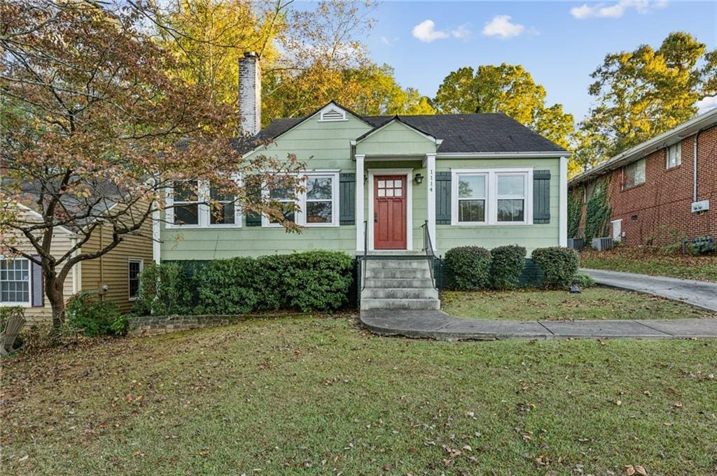 bungalow-style home with a front yard