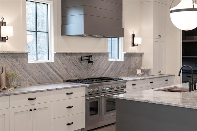 56 Pine St, Roswell, GA 30075 - kitchen featuring range with two ovens, a sink, wall chimney exhaust hood, and white cabinets