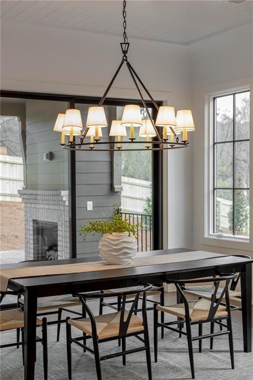 56 Pine St, Roswell, GA 30075 - dining area featuring a chandelier, plenty of natural light, and a fireplace