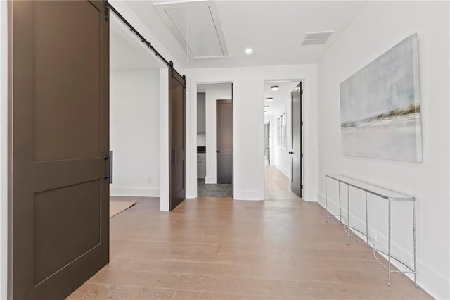 56 Pine St, Roswell, GA 30075 - hall with recessed lighting, baseboards, light wood-type flooring, a barn door, and attic access