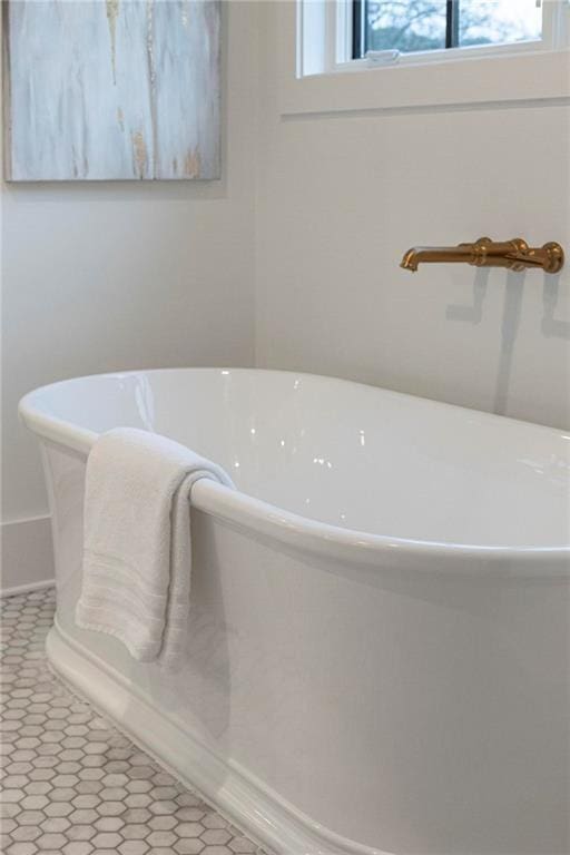 56 Pine St, Roswell, GA 30075 - bathroom featuring a freestanding bath and baseboards