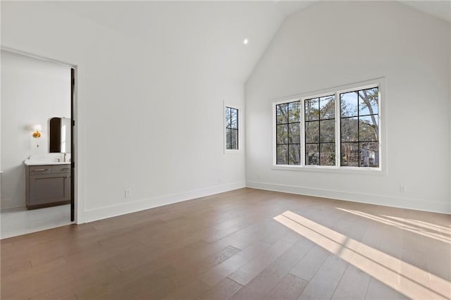 56 Pine St, Roswell, GA 30075 - spare room with wood finished floors, high vaulted ceiling, baseboards, and recessed lighting
