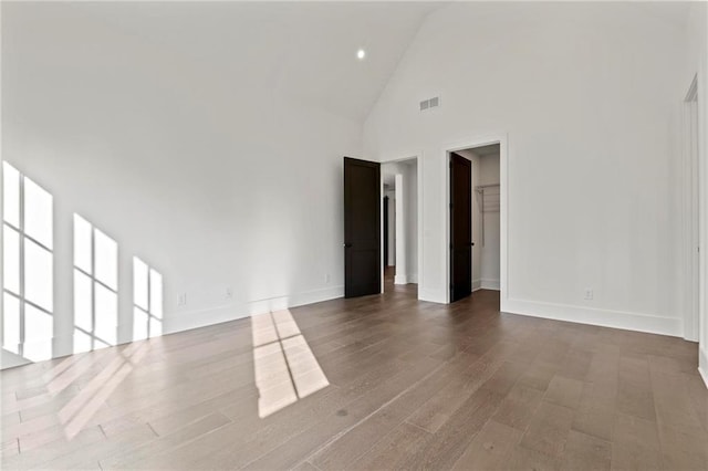 56 Pine St, Roswell, GA 30075 - empty room with high vaulted ceiling, baseboards, wood finished floors, and recessed lighting