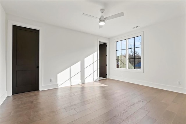 56 Pine St, Roswell, GA 30075 - empty room featuring ceiling fan, wood finished floors, and baseboards