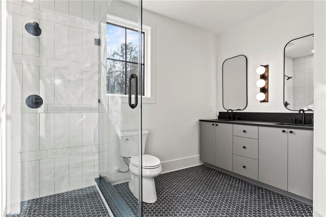 56 Pine St, Roswell, GA 30075 - bathroom with toilet, a tile shower, double vanity, baseboards, and tile patterned floors
