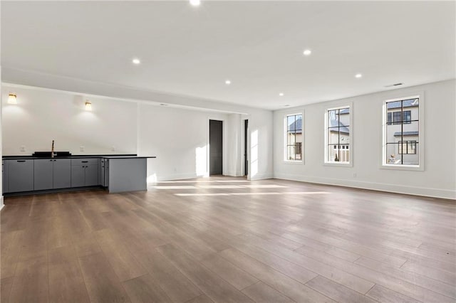 56 Pine St, Roswell, GA 30075 - unfurnished living room featuring plenty of natural light, dark wood finished floors, recessed lighting, and baseboards