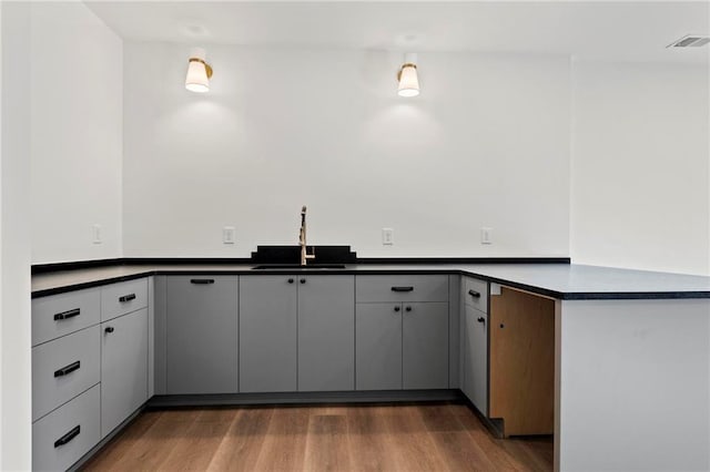 56 Pine St, Roswell, GA 30075 - kitchen with a sink, dark countertops, a peninsula, and wood finished floors