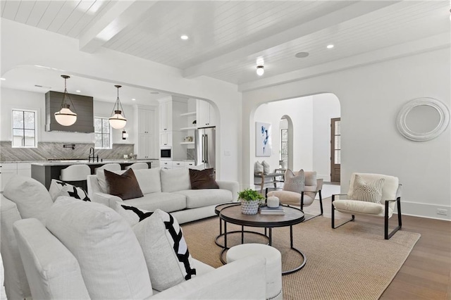 56 Pine St, Roswell, GA 30075 - living room with arched walkways, wood finished floors, beam ceiling, recessed lighting, and baseboards