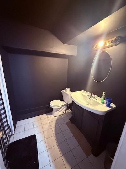 bathroom featuring tile patterned floors, toilet, and vanity