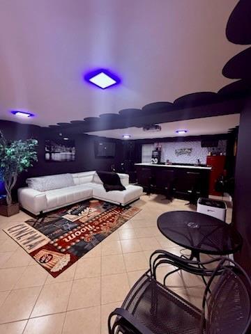 tiled living room with a dry bar