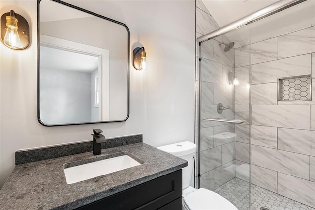 full bathroom with a shower stall, toilet, and vanity