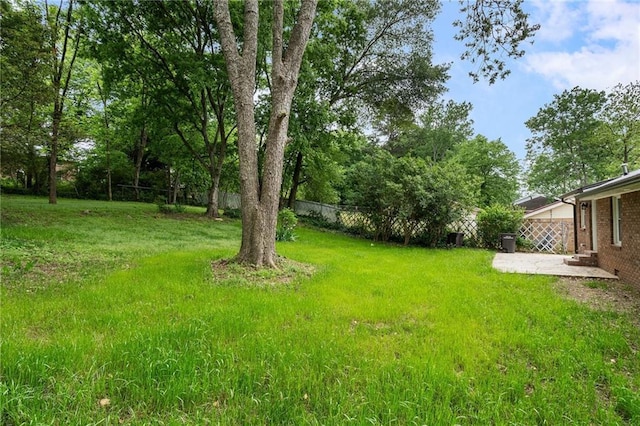 view of yard featuring a patio and fence