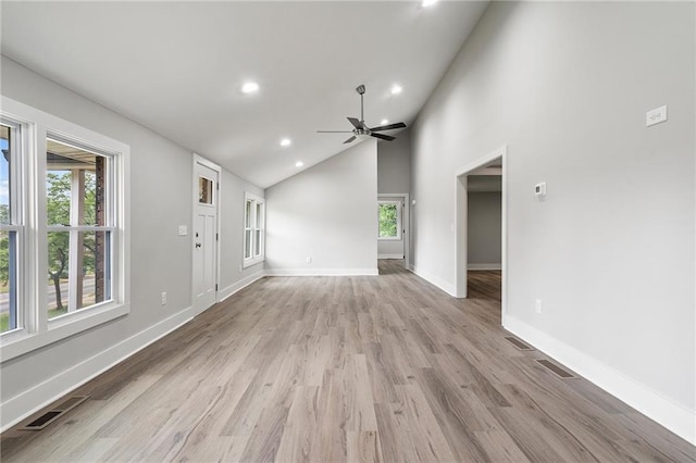 unfurnished living room featuring a healthy amount of sunlight, a ceiling fan, recessed lighting, and baseboards