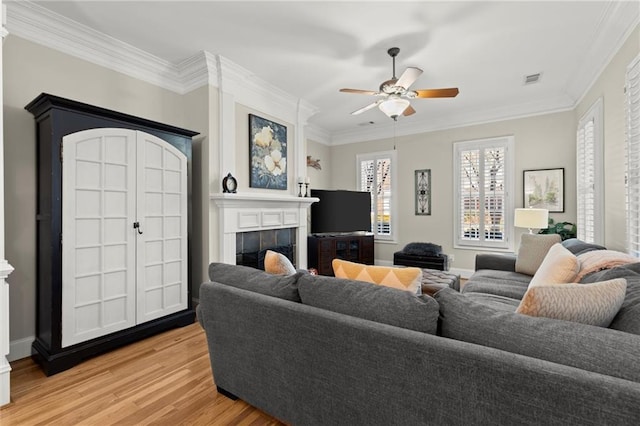 8730 Parker Pl, Roswell, GA 30076 - living room featuring light wood-style flooring, a tile fireplace, ceiling fan, ornamental molding, and baseboards