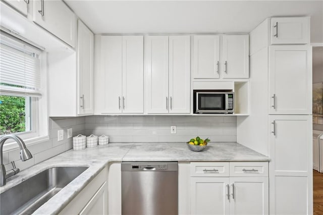 1118 Creekdale Dr, Clarkston, GA 30021 - kitchen with appliances with stainless steel finishes, a sink, and white cabinetry