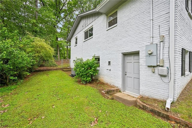 1118 Creekdale Dr, Clarkston, GA 30021 - view of side of home with brick siding, a yard, and board and batten siding