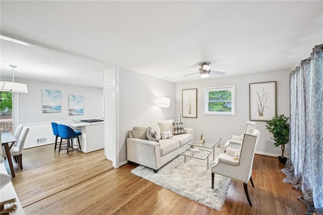 1118 Creekdale Dr, Clarkston, GA 30021 - living area featuring ceiling fan, wood finished floors, and baseboards