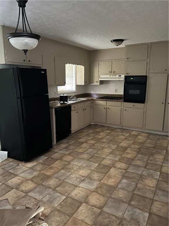 kitchen featuring sink, a textured ceiling, black appliances, and pendant lighting