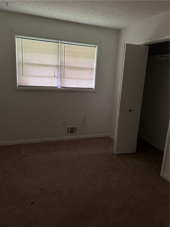 unfurnished bedroom with a closet