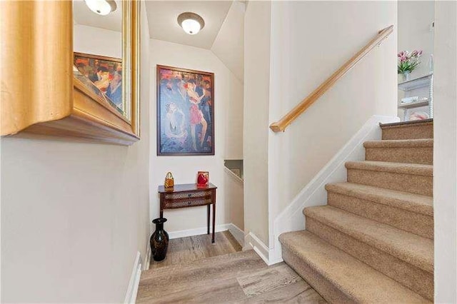 stairs featuring hardwood / wood-style flooring