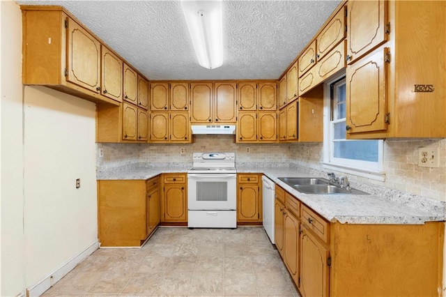 kitchen featuring tasteful backsplash, sink, white appliances, and a textured ceiling