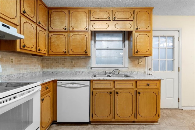 kitchen with tasteful backsplash, sink, white appliances, and a textured ceiling