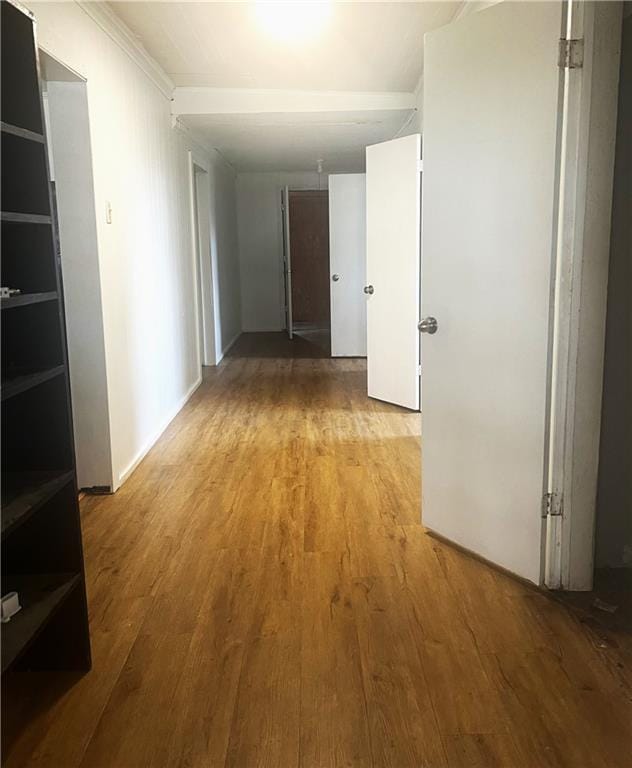 hall featuring ornamental molding and light hardwood / wood-style floors