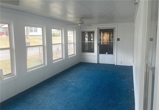 unfurnished sunroom with ceiling fan