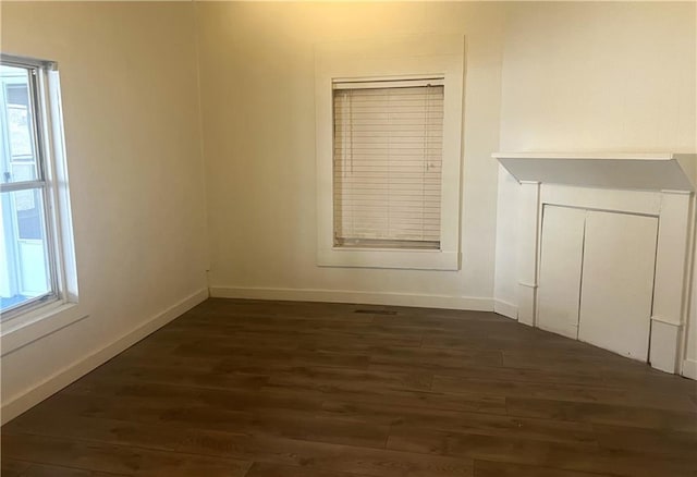 unfurnished room featuring dark wood-type flooring