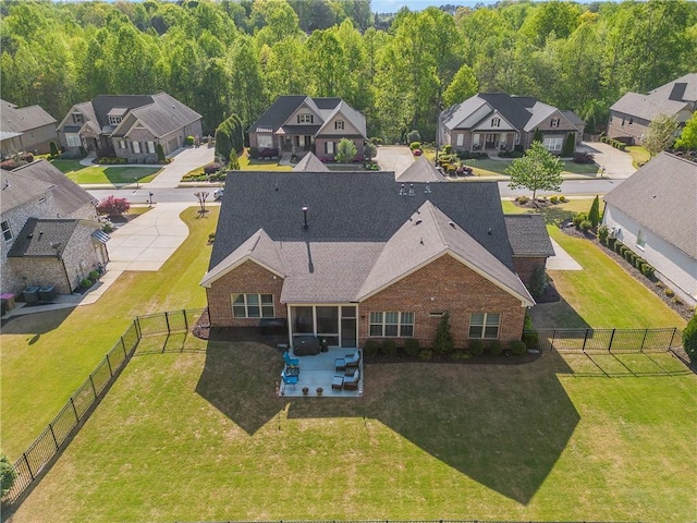 aerial view of residential area featuring a heavily wooded area